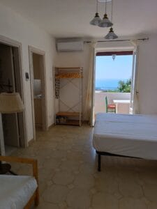Bright bedroom at La Quercia di Villa Olivia with access to the balcony